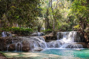 Kuang Si Waterfall, Laos. Beautiful turquoise water surrounded by trees.