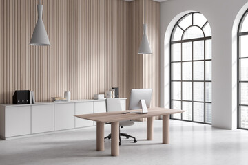 Light business interior with workspace, pc computer and panoramic window. Empty wall