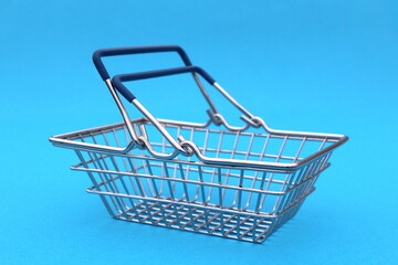 An iron miniature basket stands on a blue background.