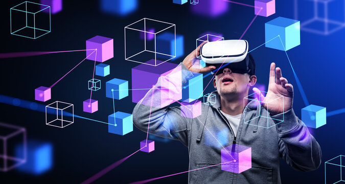 Young man in vr glasses touching blocks in cyberspace, metaverse