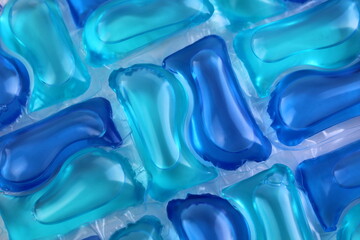 Abstract texture from bright blue laundry capsules.