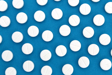 Abstract background of white pills on a blue background