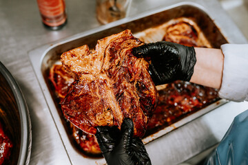 raw meat marinated in sauce for barbecue in a metal Cup