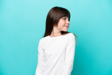 Little caucasian girl isolated on blue background . Portrait