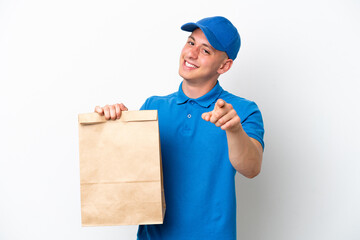Young Brazilian man taking a bag of takeaway food isolated on white background pointing front with happy expression
