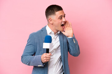Young brazilian presenter man isolated on pink background shouting with mouth wide open to the side