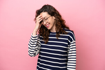 Young caucasian woman isolated on pink background laughing