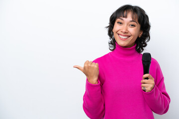 Young Argentinian singer woman isolated on white background pointing to the side to present a...