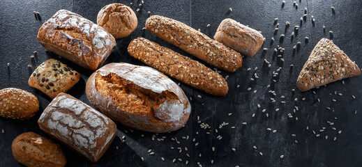 Assorted bakery products including loaves of bread and rolls