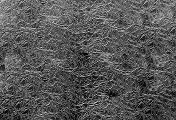 Crumpled silver foil surface top view.