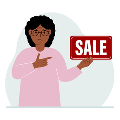 A woman holds a banner with the text sale. Points a finger at the text. The concept of a discount, a special offer in a store or a bank, an advertising flyer.