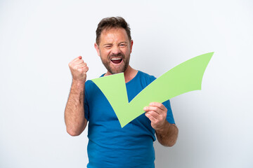 Middle age caucasian man isolated on white background holding a check icon and celebrating a victory