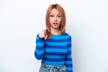 Fototapeta premium Young Russian girl isolated on white background surprised and pointing front