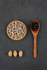 Raw and boiled pearl tapioca on a dark background with brown sugar. Top view.