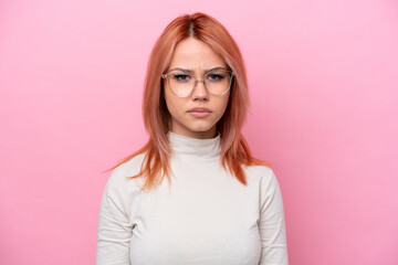 Young Russian girl isolated on pink background With glasses