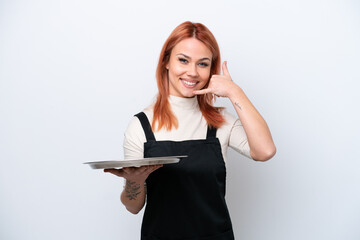 Fototapeta premium Young Russian waiter with tray isolated on white background making phone gesture. Call me back sign