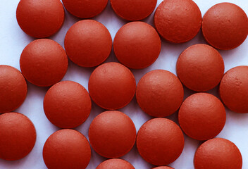 Red pills on a blue background top view.