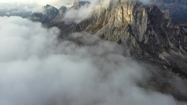 Tracking drone video showing low level clouds covering the Dolomites, Italy 