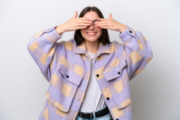 Young girl isolated on white background covering eyes by hands and smiling
