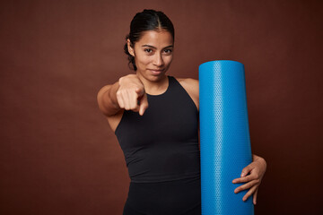 Young athlete embracing yoga and fitness with a mat.