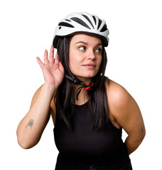 Young caucasian woman wearing a helemet isolated trying to listening a gossip.