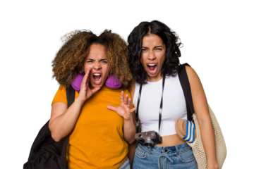 Two diverse friends on a beach vacation with vintage camera, beach bag, and travel pillow screaming very angry and aggressive.