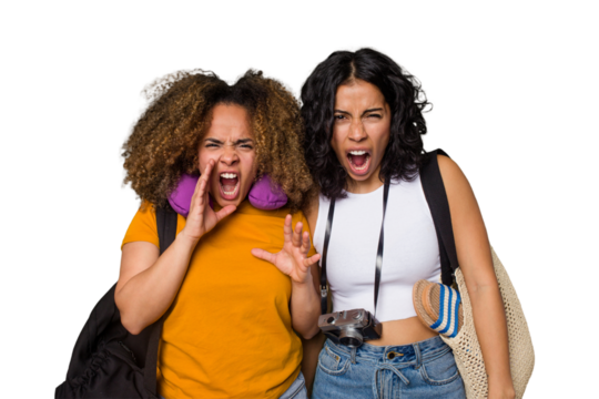 Two diverse friends on a beach vacation with vintage camera, beach bag, and travel pillow screaming very angry and aggressive.