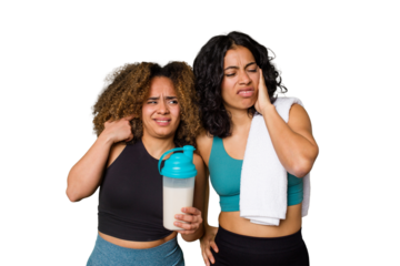 Two best friends are ready to go to the gym, one of them holds a protein shake, covering ears with hands.