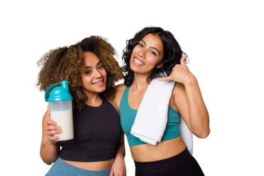 Two best friends are ready to go to the gym, one of them holds a protein shake, showing a mobile phone call gesture with fingers.