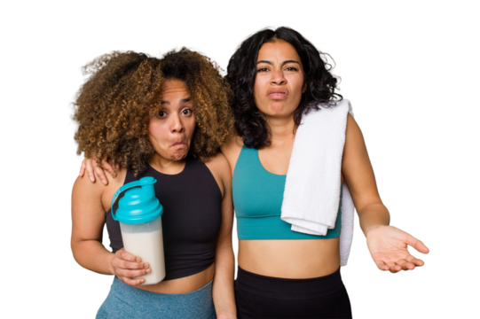 Two best friends are ready to go to the gym, one of them holds a protein shake, shrugs shoulders and open eyes confused.