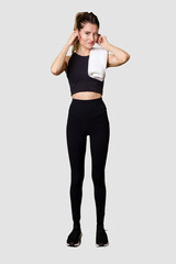 Full body of young woman in sportswear, fit and athletic, embodying a healthy and active...