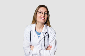 Fototapeta premium Compassionate female physician with a stethoscope around her neck, ready to diagnose and care for her patients in her signature white coat laughing and having fun.