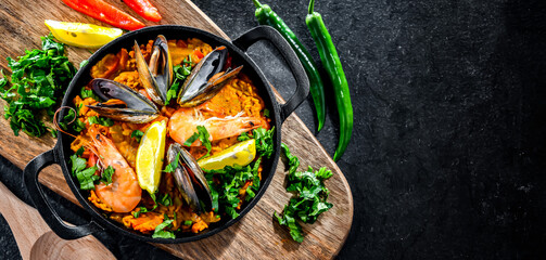 Seafood paella served in a cast iron pan