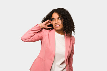 Young african american curly woman isolated covering ears with hands.