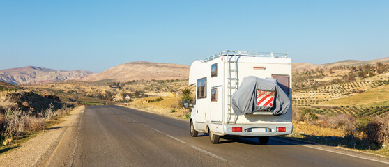 motorhome on the road- vacation,  travel or adventure concept