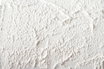 Rough texture of white putty on a wall