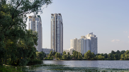 Fototapeta na wymiar Modern multistory apartment complex on the river bank