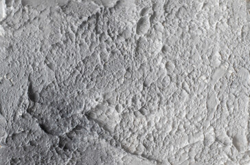 Light wallpaper background, textured putty, plaster in white and grey. Empty design space. Marble painting. Close-up
