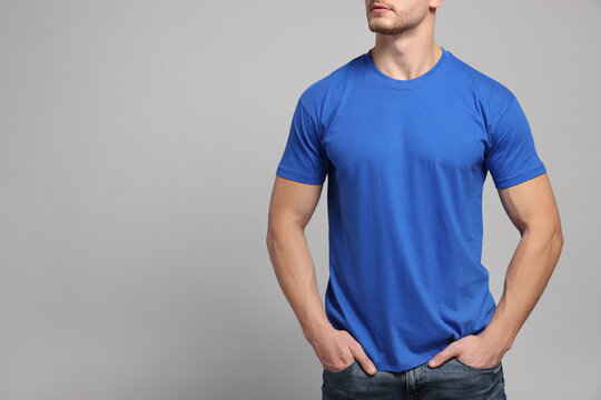 Man wearing blue t-shirt on light grey background, closeup. Mockup for design
