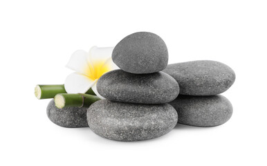 Fototapeta na wymiar Spa stones with flower and bamboo stems isolated on white