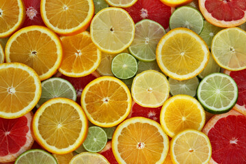 Different citrus fruits as background, top view
