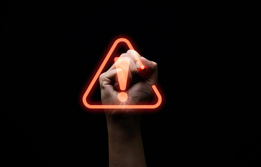 Hand writing red triangle caution exclamation warning sign for notification error and maintenance...