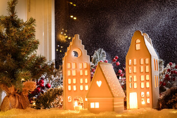 Obraz premium House shaped lanterns and Christmas decor on windowsill indoors