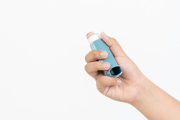 Asian boy hand holding asthma inhaler on white background with space for text