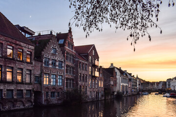 Naklejka premium Canal houses in Ghent, Belgium during sunset