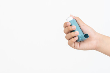 Asian boy hand holding asthma inhaler on white background with space for text