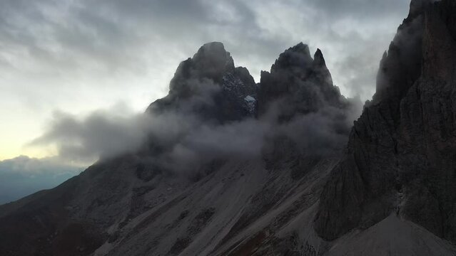 Tracking drone video showing low level clouds covering the Dolomites, Italy 