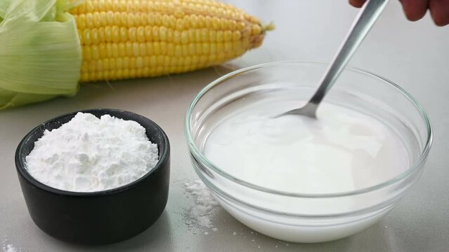 Mixing cornstarch and water in a bowl.