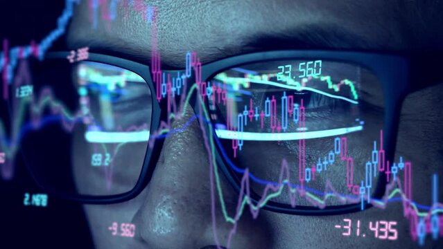 Close-up camera to trader's glasses analyzing stock charts