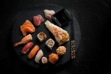 sushi mix with chopstick over black stone